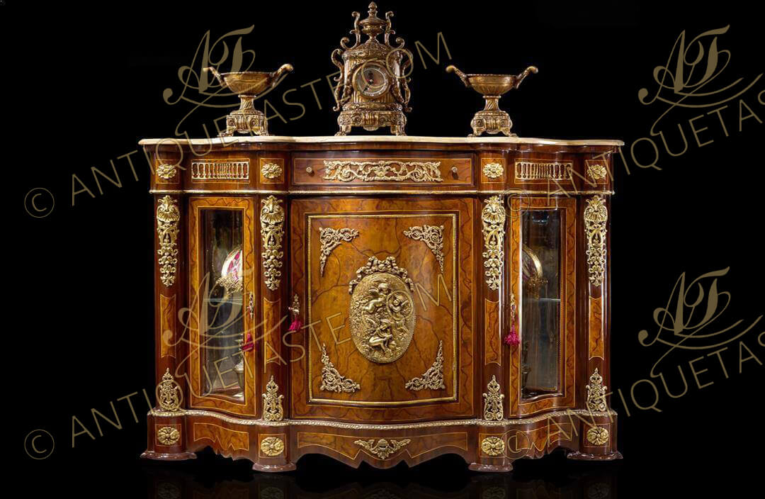 Napoleon III style ormolu mounted veneer inlaid serpentine shape credenza, The serpentine shape eared marble top above a foliate ormolu mounted frieze drawer surmounting a central door centered with a fine chiseled ormolu plaque representing winged cherubs and putti, Flanked to each side by a serpentine shaped glass doors above a serpentine shaped plinth, The fine credenza is intricately inlaid with exceptional pattern and ornamented with lavish decoration of ormolu mounts of empire columned gats, foliate acanthus motifs, scalloped leafy pendants, flower rosettes, intertwined foliate works and beaded strap-works